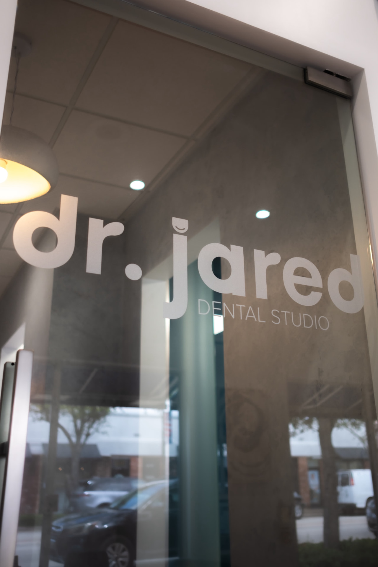 Dr Jared Dental Studio logo on the glass entrance